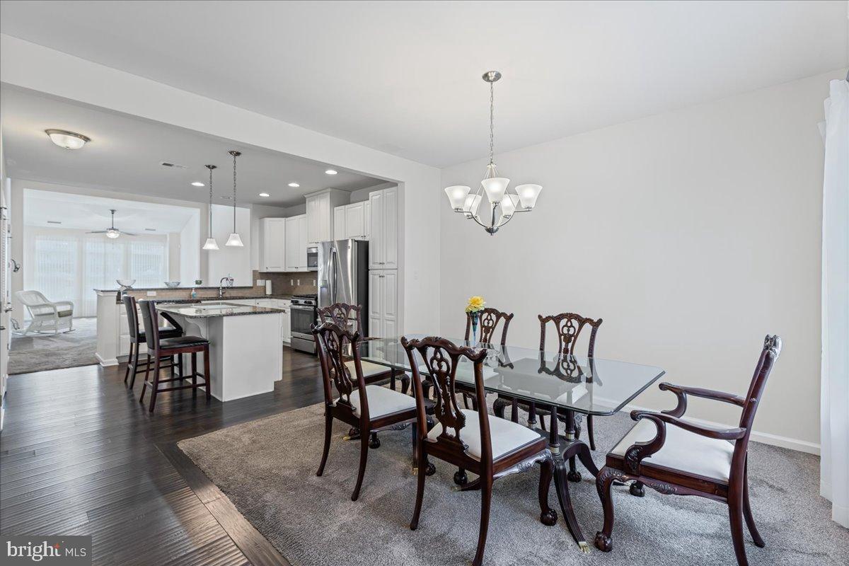 54 Heals Farm Road Burlington, NJ 08016 - Photo 3 of 26 a view of a dining room with furniture wooden floor and chandelier