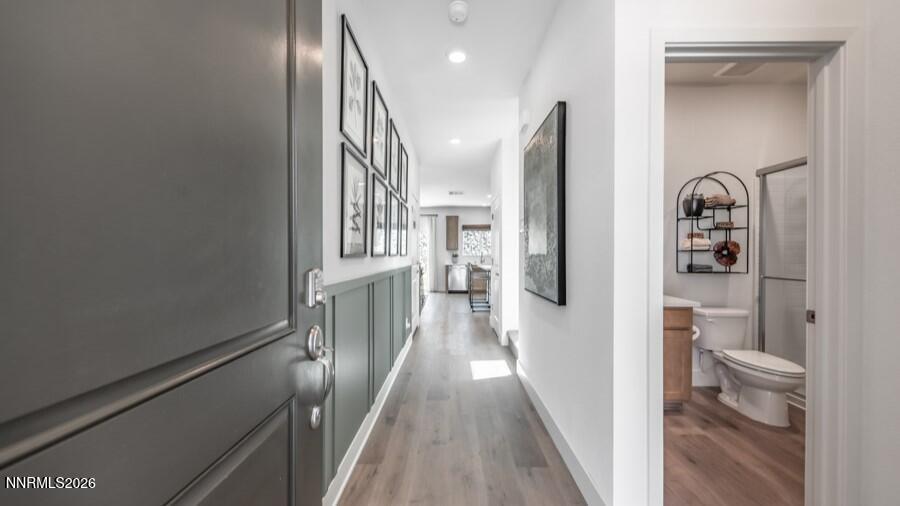 494 Daisy Fay Way Carson City, NV 89705 - Photo 2 of 28 a view of a hallway with wooden floor and a living room