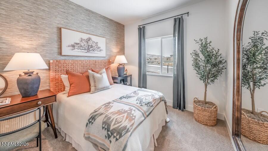 494 Daisy Fay Way Carson City, NV 89705 - Photo 23 of 28 a bedroom with a bed and a potted plant