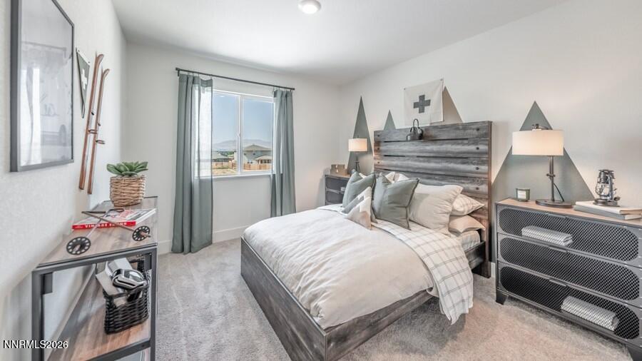 494 Daisy Fay Way Carson City, NV 89705 - Photo 26 of 28 a bedroom with a bed and wooden floor