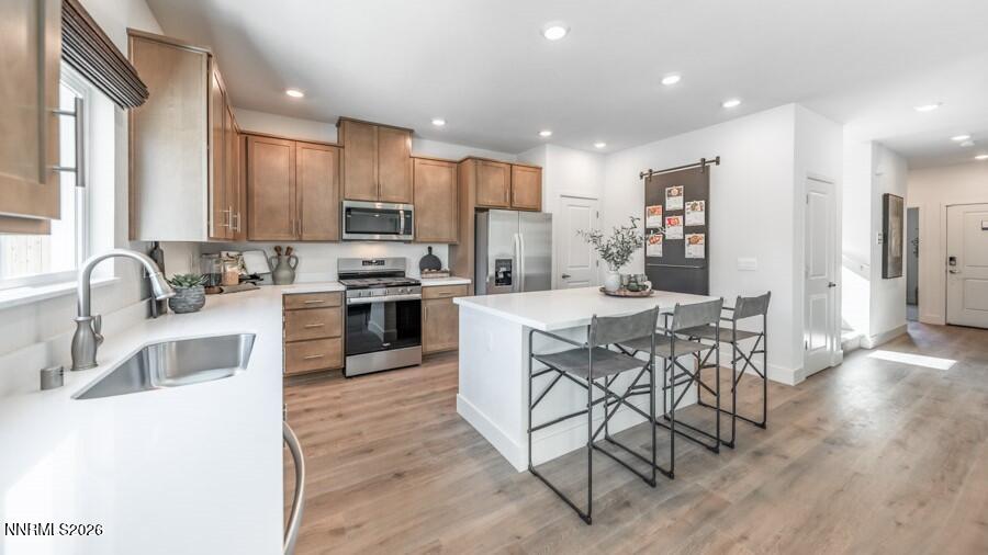 494 Daisy Fay Way Carson City, NV 89705 - Photo 6 of 28 a kitchen with stainless steel appliances kitchen island granite countertop a sink and a refrigerator