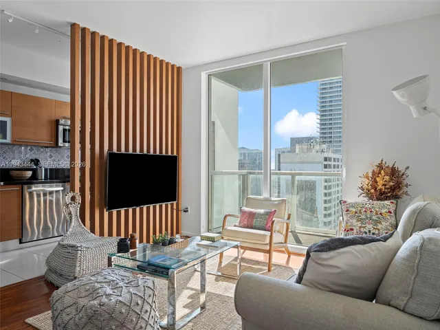 a living room with furniture fireplace and flat screen tv