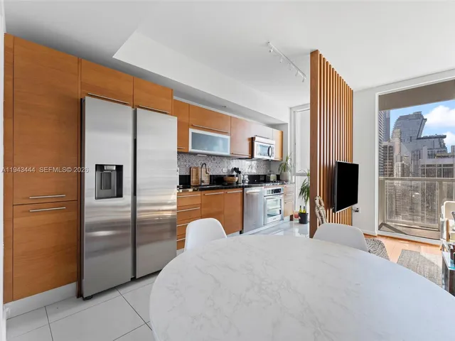 a kitchen with stainless steel appliances granite countertop a refrigerator oven a sink and dishwasher