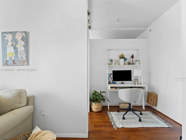 a workspace with furniture and wooden floor