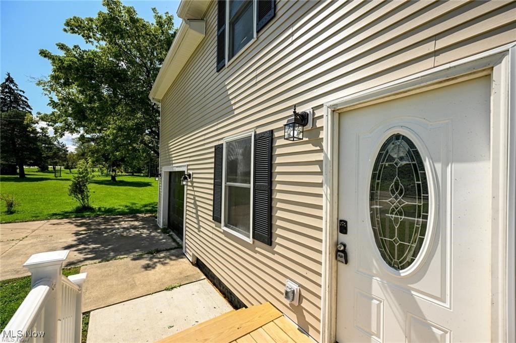 7613 Jefferson Road Ashtabula, OH 44004 - Photo 6 of 35 View of exterior entry featuring a yard