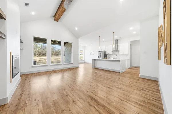 a view of kitchen and hall with wooden floor