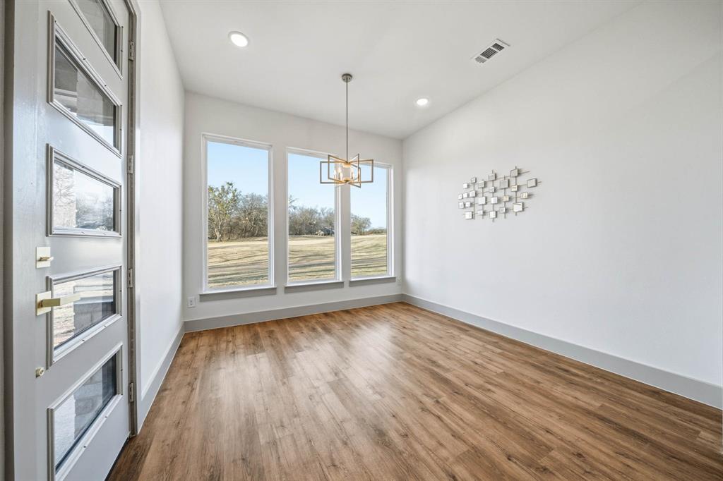 39290 Cedar Trail Whitney, TX 76692 - Photo 19 of 40 a view of an empty room with a window and wooden floor