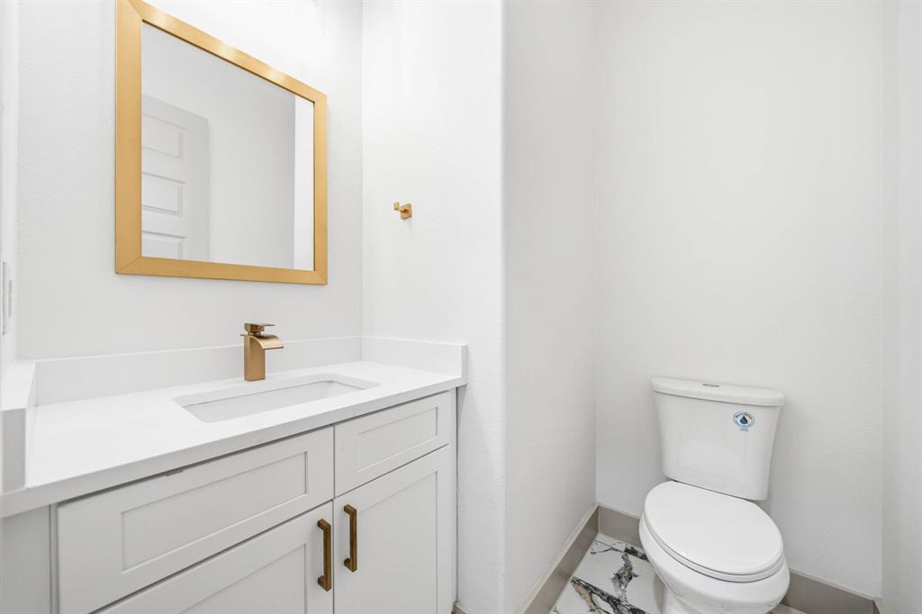 39290 Cedar Trail Whitney, TX 76692 - Photo 27 of 40 a bathroom with a toilet a sink and mirror