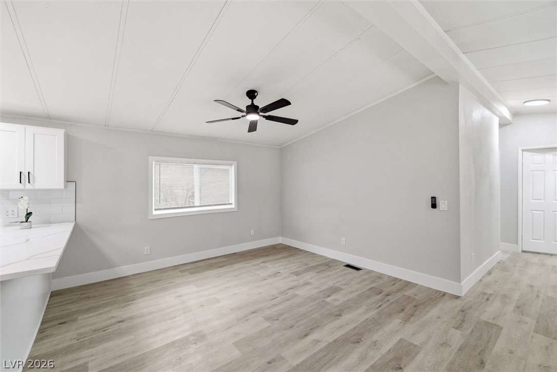 3940 Point Drive Pahrump, NV 89060 - Photo 11 of 35 Laminate flooring and a ceiling fan create a comfortable and modern interior living space.