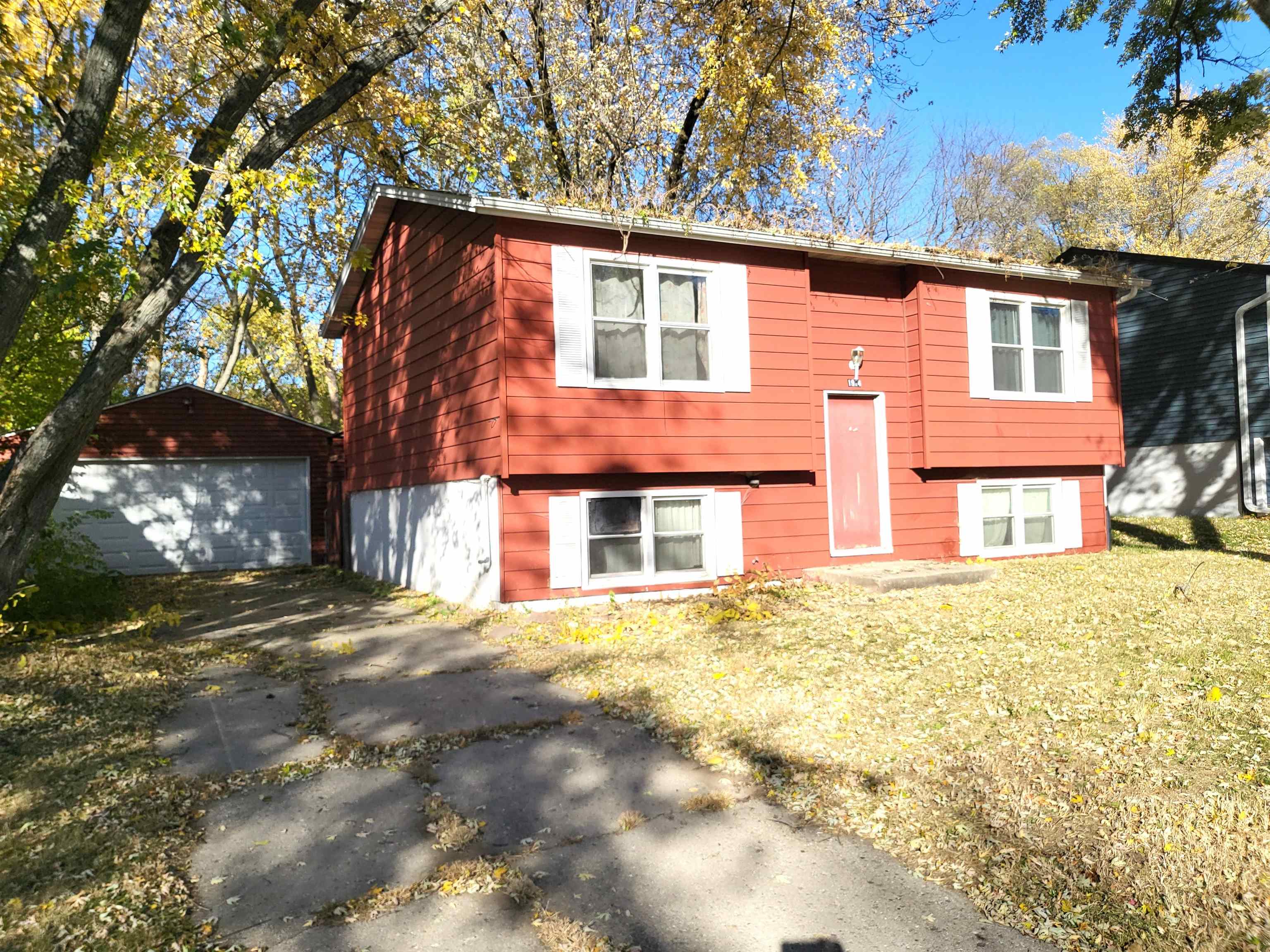a front view of a house with a yard covered with snow