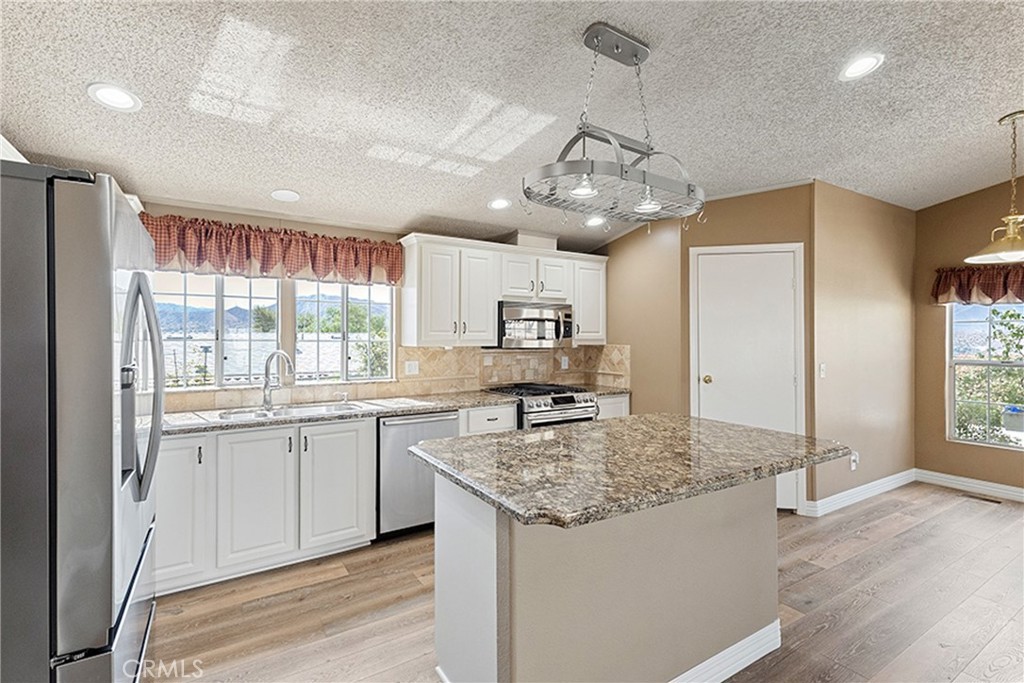 33105 Santiago Road, Unit 149 Acton, CA 93510 - Photo 13 of 28 a kitchen with stainless steel appliances granite countertop a sink stove and refrigerator