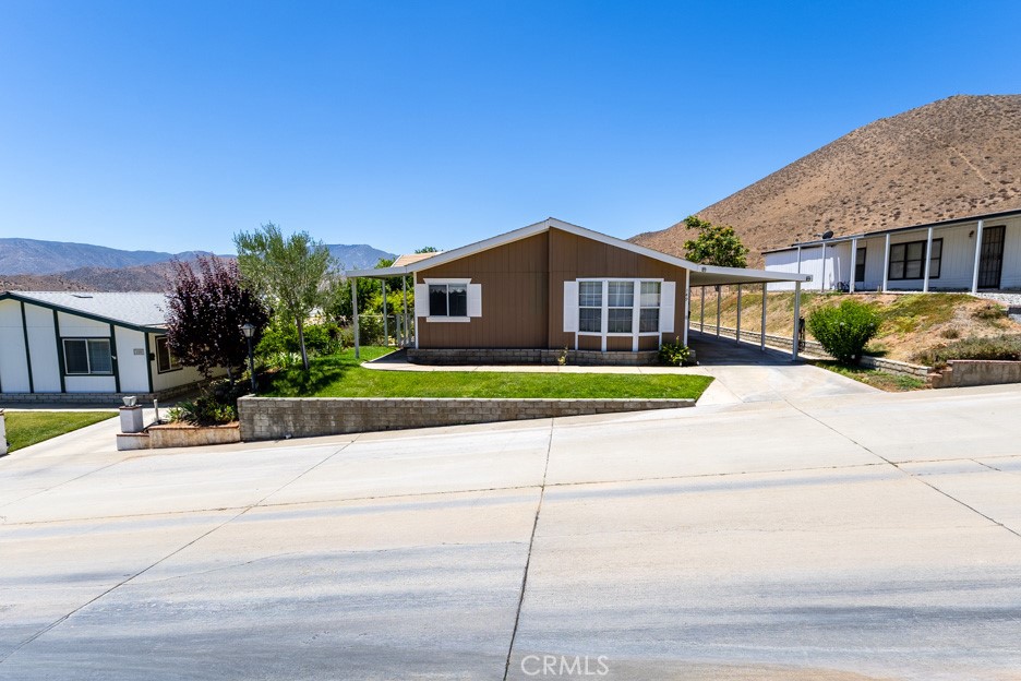 33105 Santiago Road, Unit 149 Acton, CA 93510 - Photo 2 of 28 a front view of a house with a garden and plants