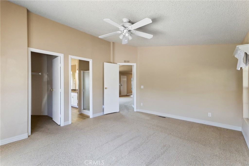 33105 Santiago Road, Unit 149 Acton, CA 93510 - Photo 22 of 28 a view of an empty room with a ceiling fan