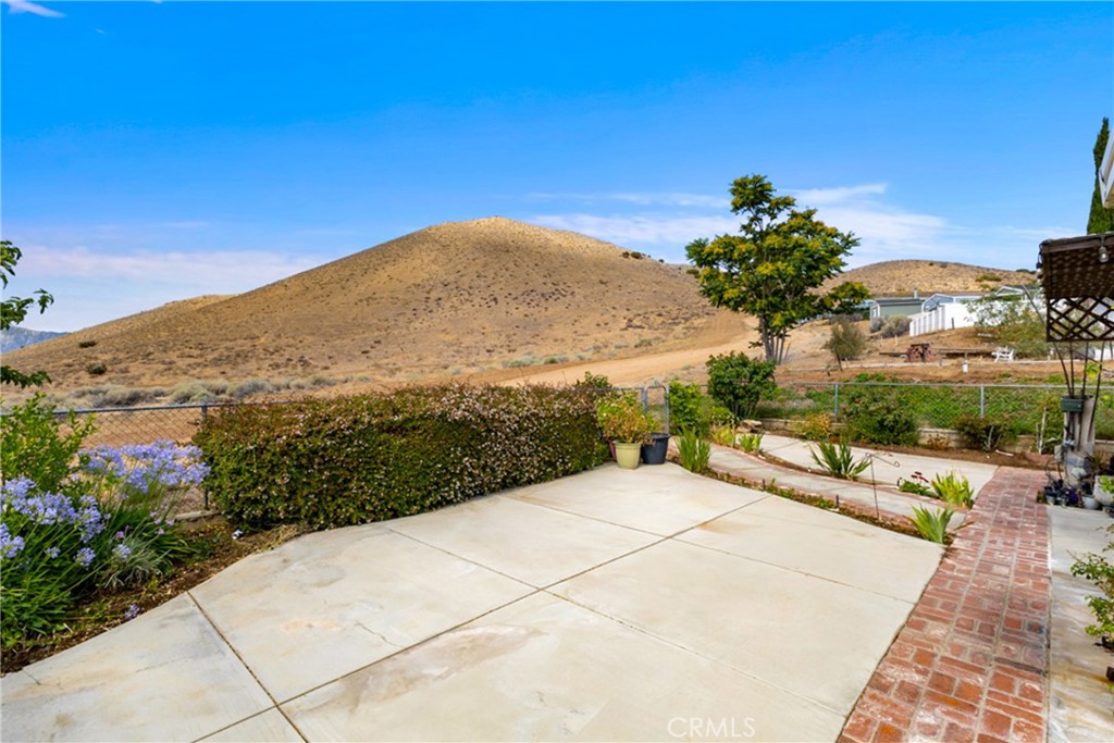 33105 Santiago Road, Unit 149 Acton, CA 93510 - Photo 8 of 28 a view of a terrace with a garden and mountain view