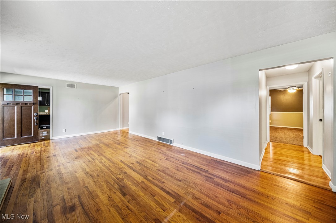 1796 Lander Road Mayfield Heights, OH 44124 - Photo 7 of 39 Unfurnished living room featuring wood-type flooring