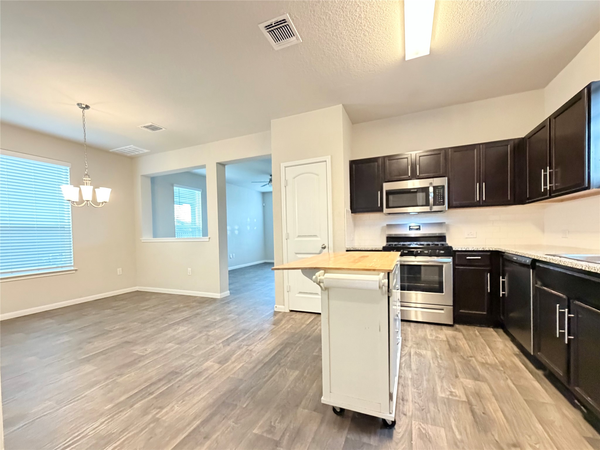 10502 Fulton Avenue Austin, TX 78754 - Photo 11 of 36 The open-concept layout creates an effortless flow between the kitchen and dining areas.