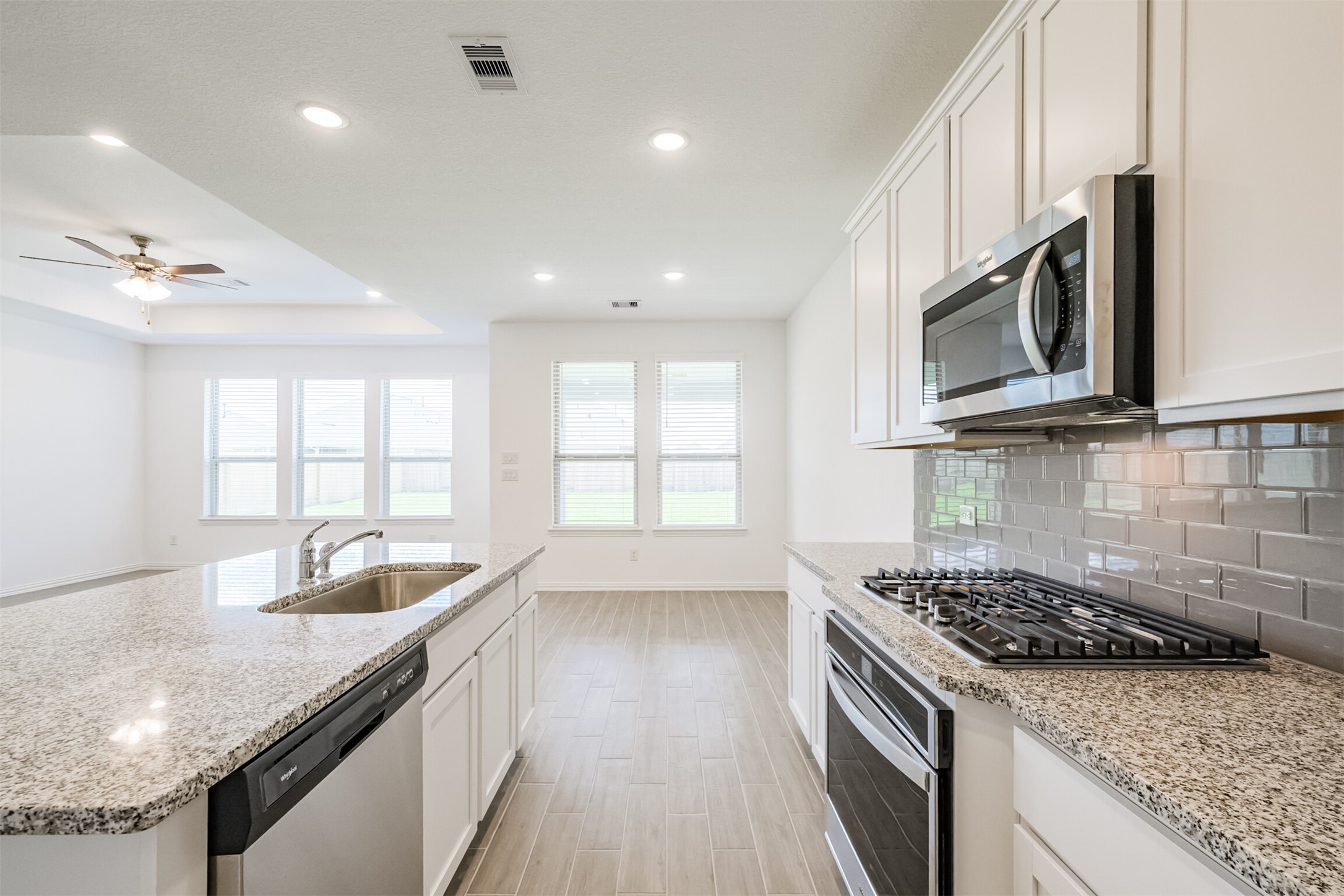 7922 Chukka Drive Fulshear, TX 77441 - Photo 12 of 39 a kitchen with granite countertop a sink and stove top oven