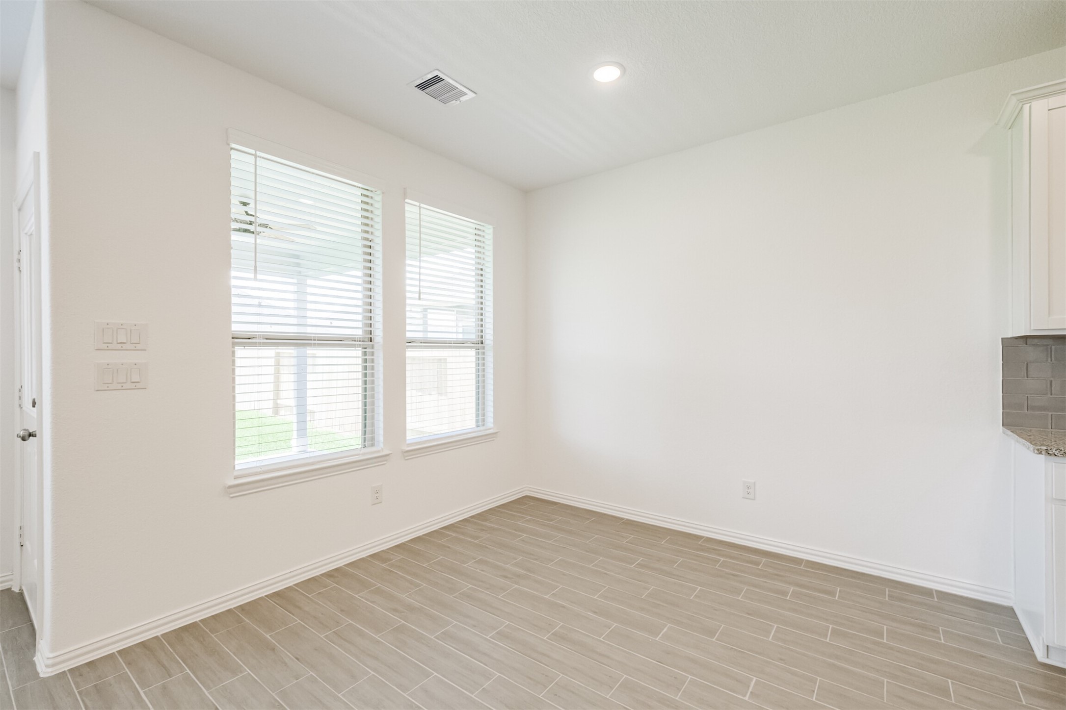 7922 Chukka Drive Fulshear, TX 77441 - Photo 19 of 39 an empty room with wooden floor and windows