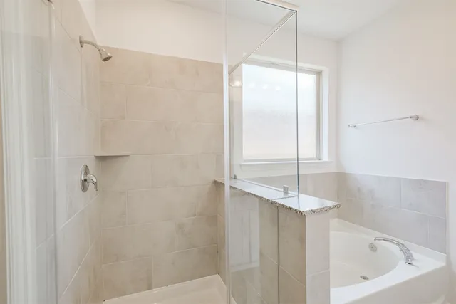 a bathroom with a bathtub and shower