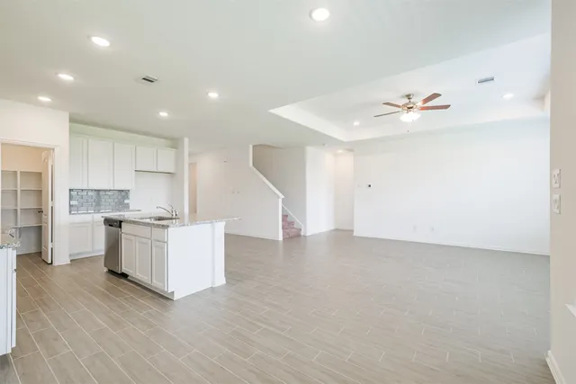 a view of kitchen with wooden floor and electronic appliances