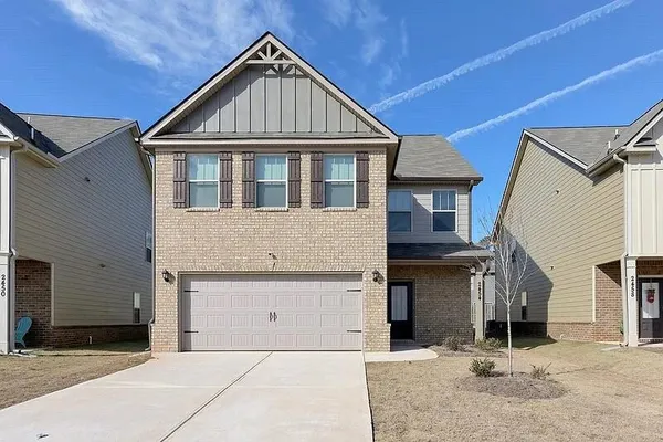 a front view of a house with a yard