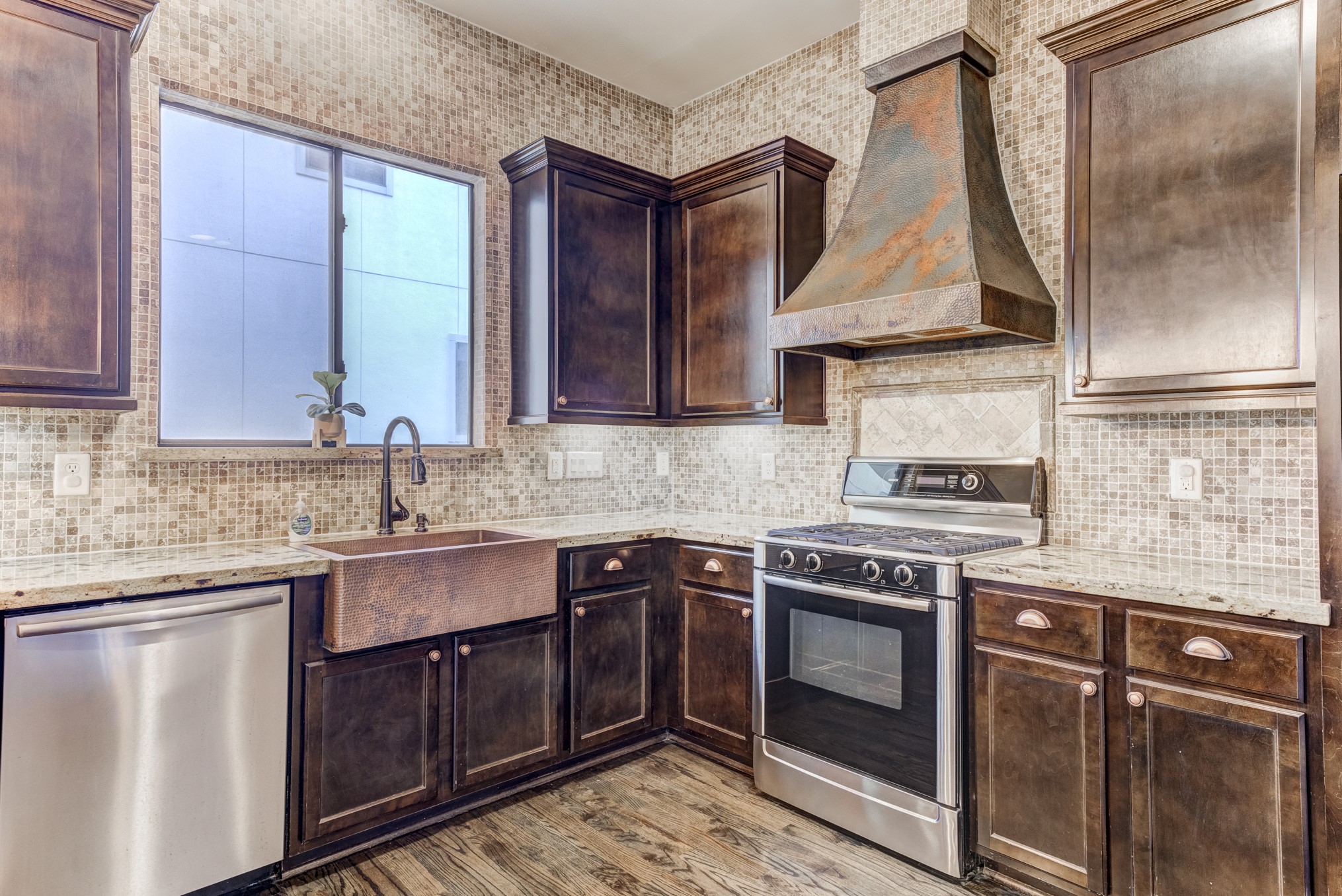 2308 Couch Street Houston, TX 77008 - Photo 21 of 50 a kitchen with a sink stove and cabinets