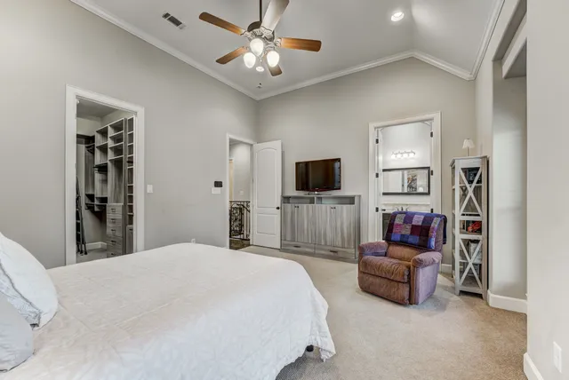 a front view of a residential apartment building with a yard and potted plants
