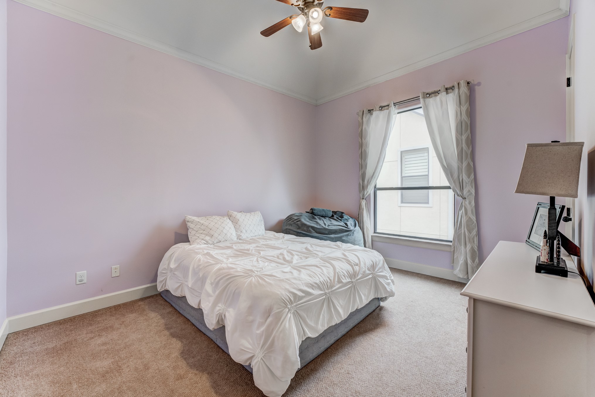 2308 Couch Street Houston, TX 77008 - Photo 36 of 50 a bedroom with a bed and a chandelier