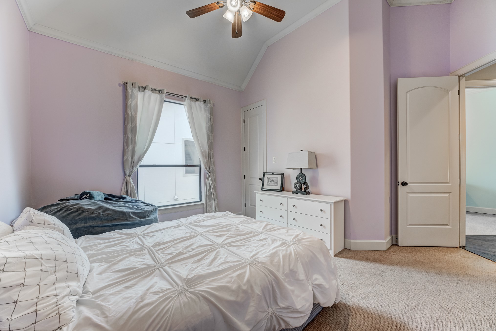 2308 Couch Street Houston, TX 77008 - Photo 37 of 50 a bedroom with a bed and a chandelier