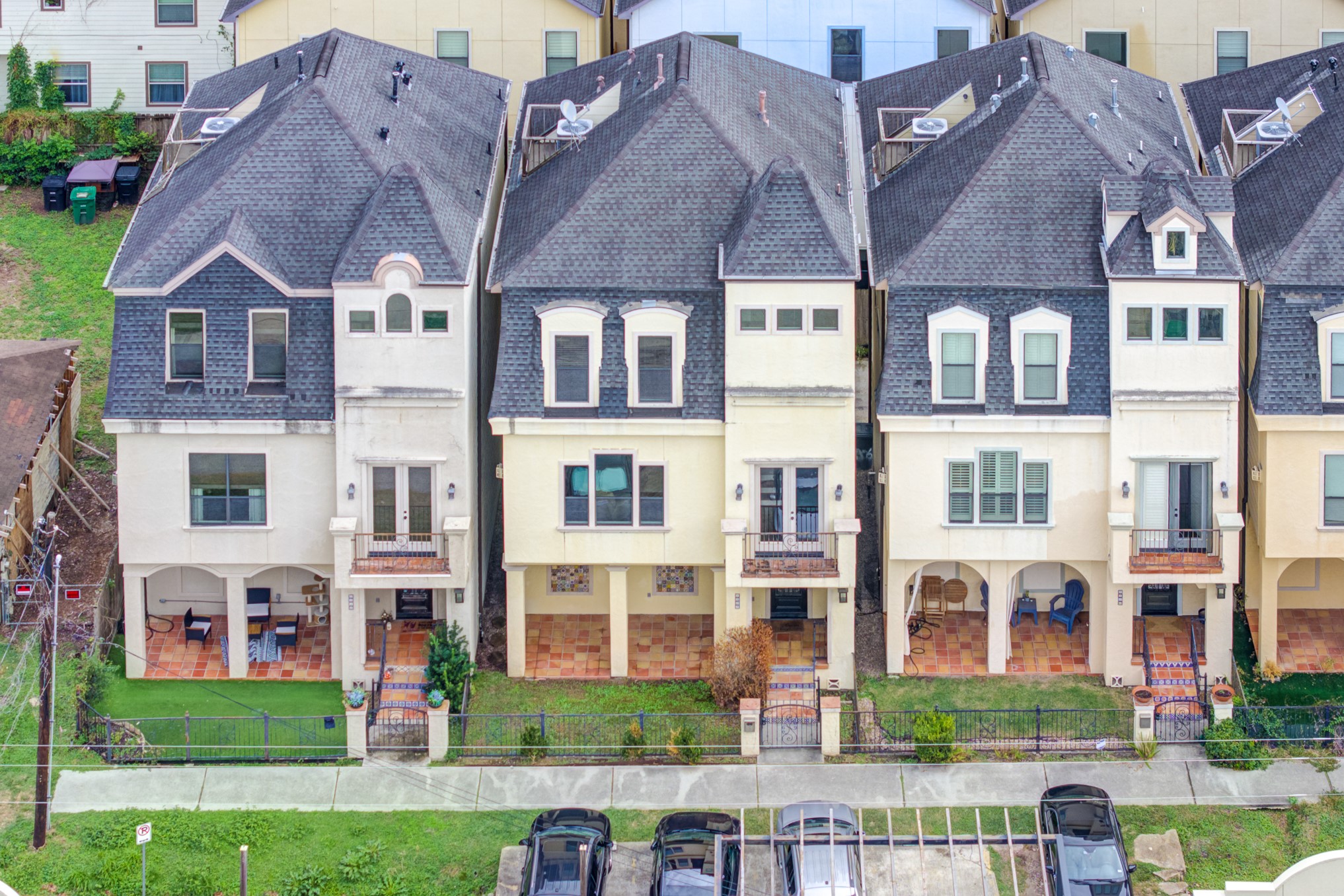 2308 Couch Street Houston, TX 77008 - Photo 45 of 50 a front view of a residential apartment building with a yard and potted plants