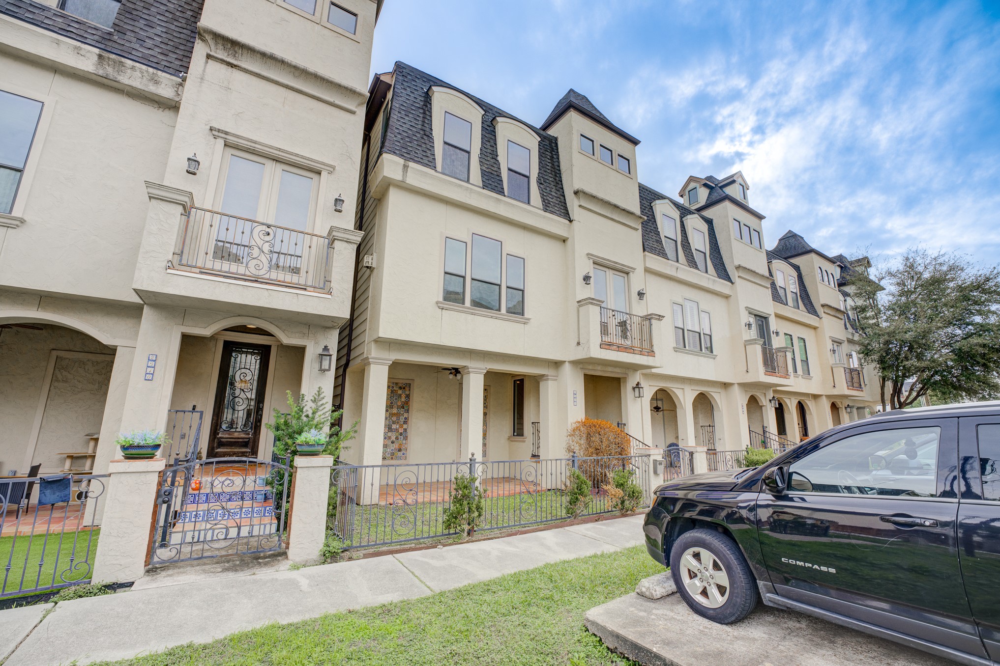 2308 Couch Street Houston, TX 77008 - Photo 6 of 50 a car parked in front of a white house