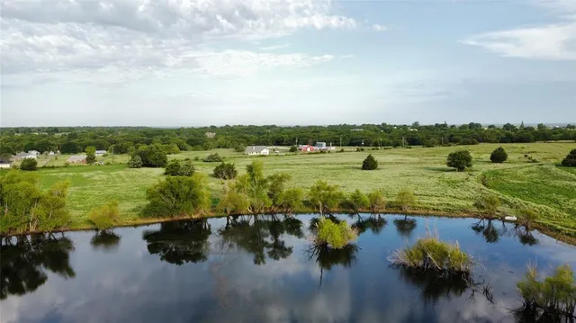 a view of a lake with houses in the back