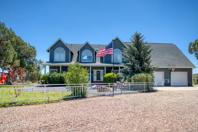 an aerial view of a house with a yard and outdoor seating