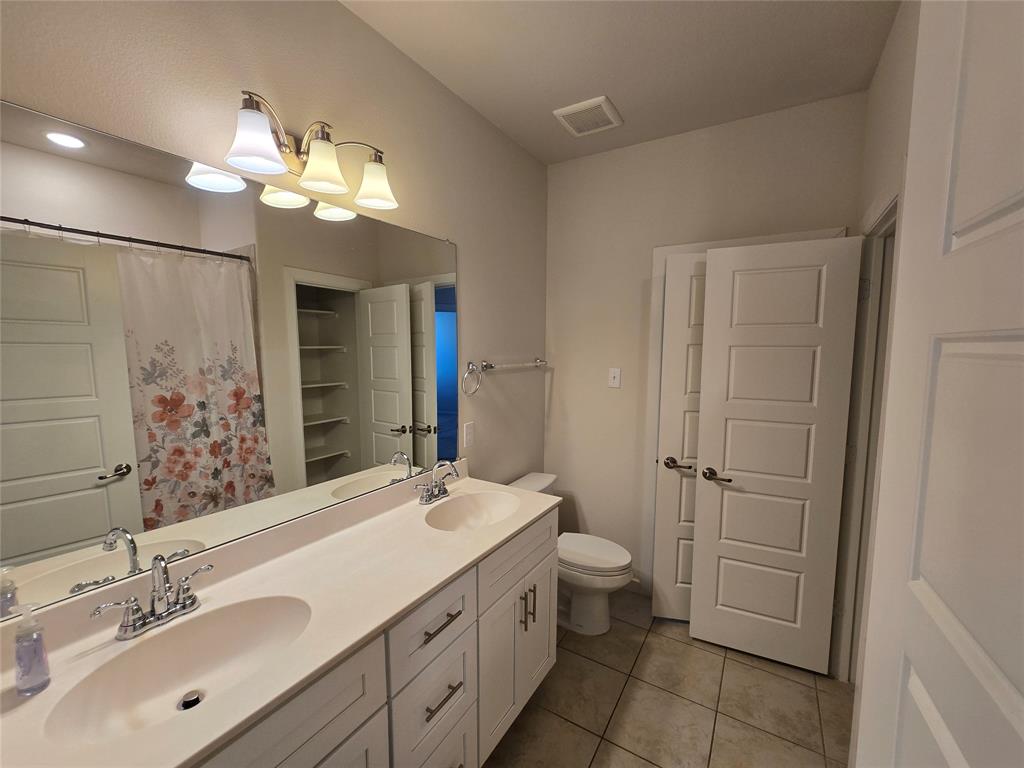 508 Williams Way Van Alstyne, TX 75495 - Photo 18 of 26 a bathroom with a double vanity sink mirror and toilet
