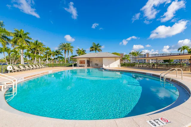 a swimming pool with outdoor seating