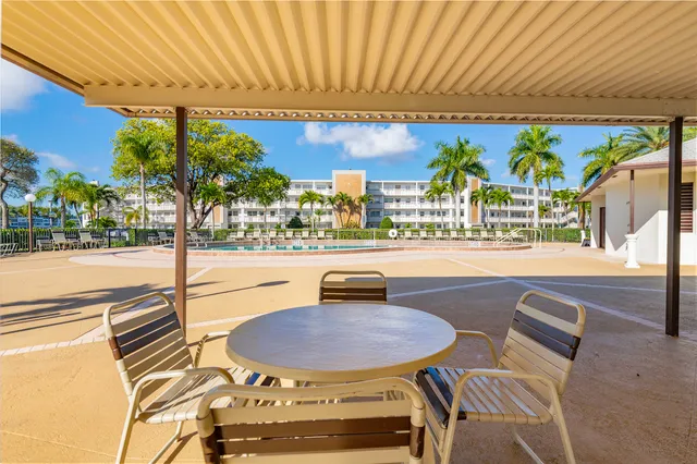 a view of a swimming pool with a deck and a potted plants