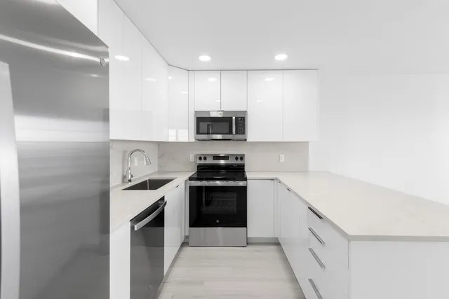 a kitchen with a sink and a stove top oven