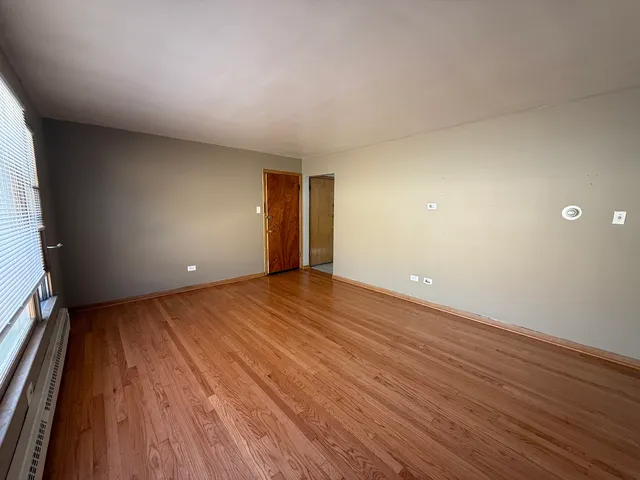 a view of an empty room and wooden floor