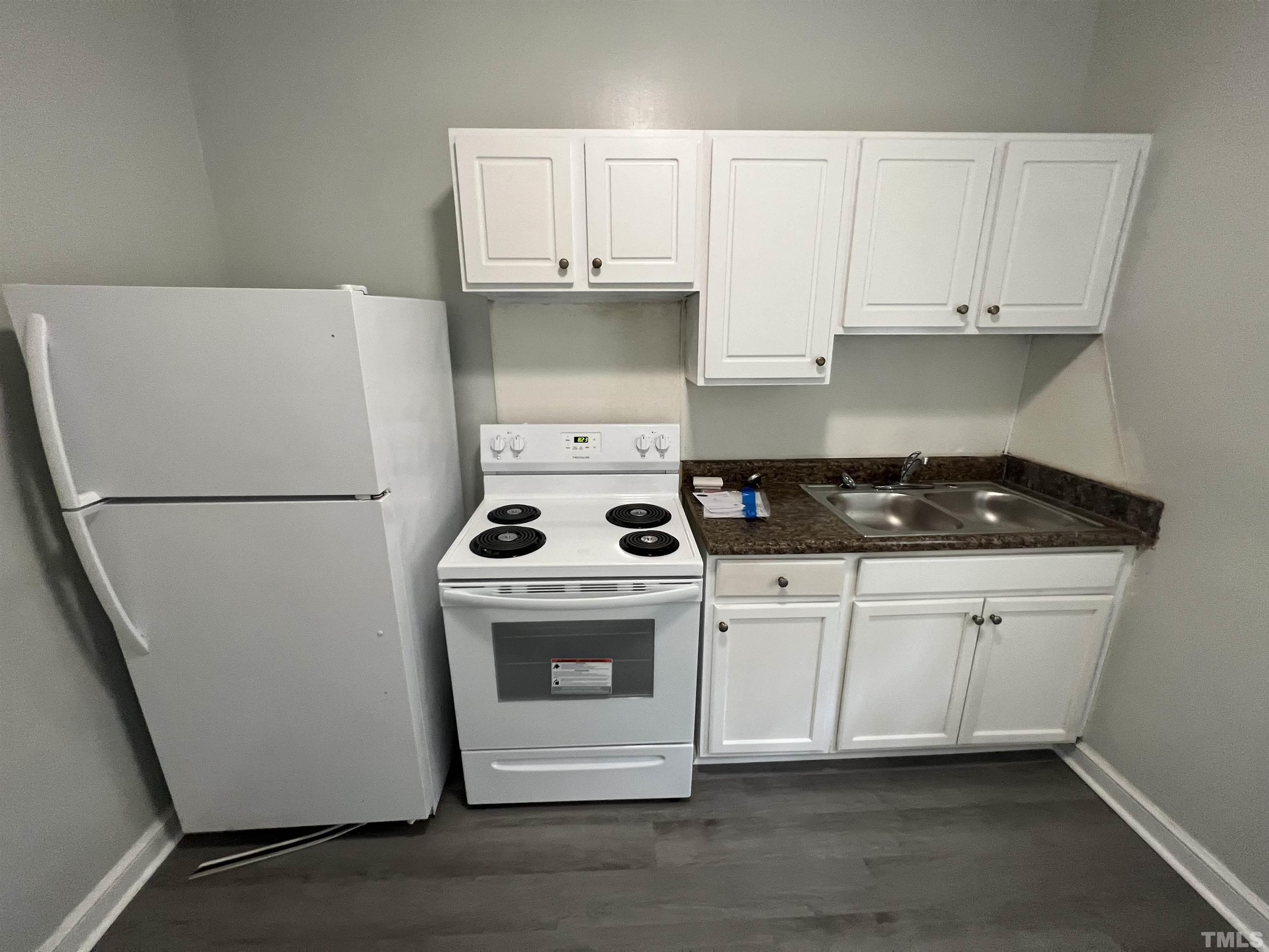 2501 Pickett Road, Unit 5 Durham, NC 27705 - Photo 13 of 17 a white stove top oven sitting inside of a white kitchen