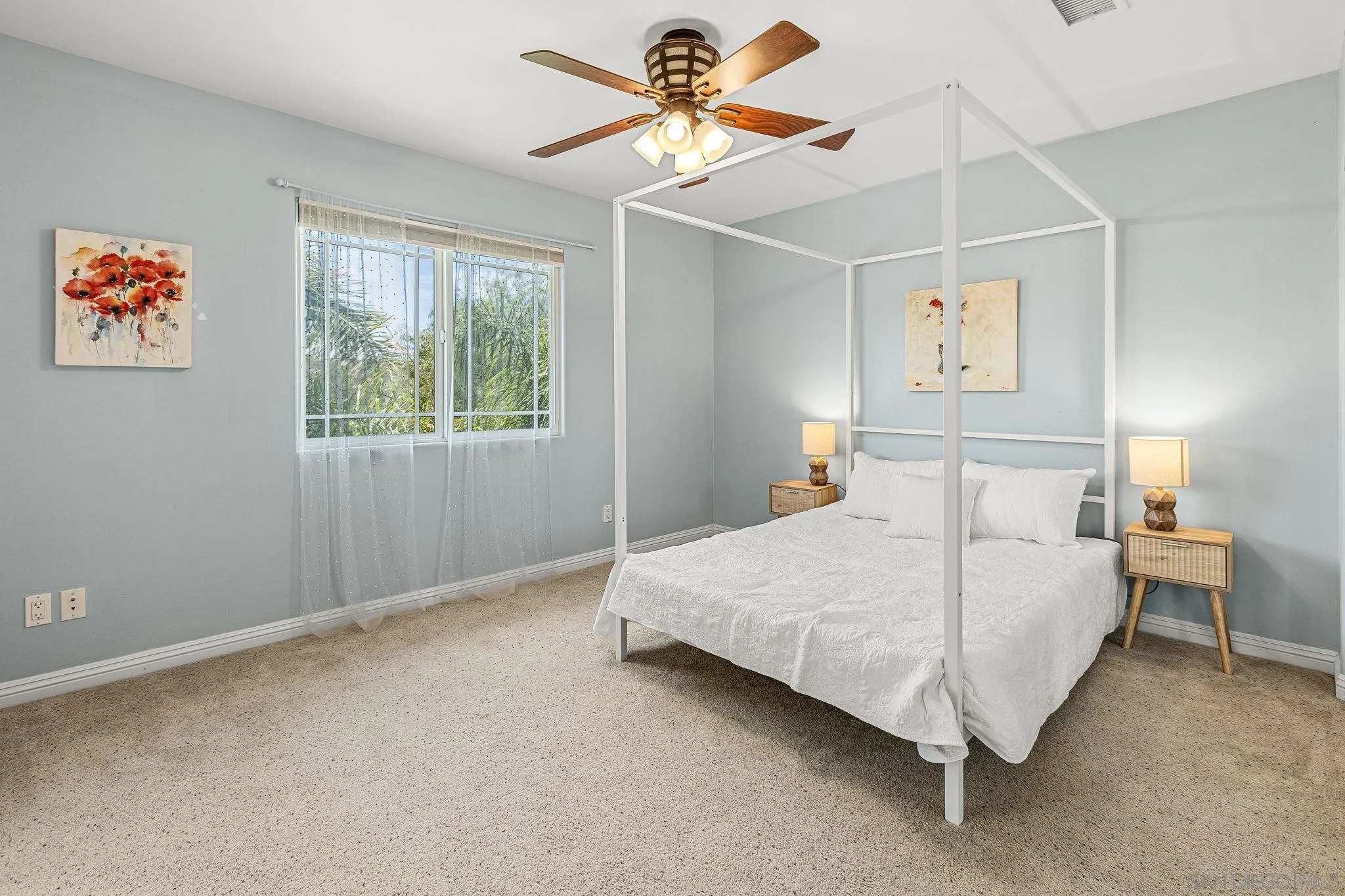 25919 Matlin Road Ramona, CA 92065 - Photo 19 of 42 a bedroom with a bed and a chandelier