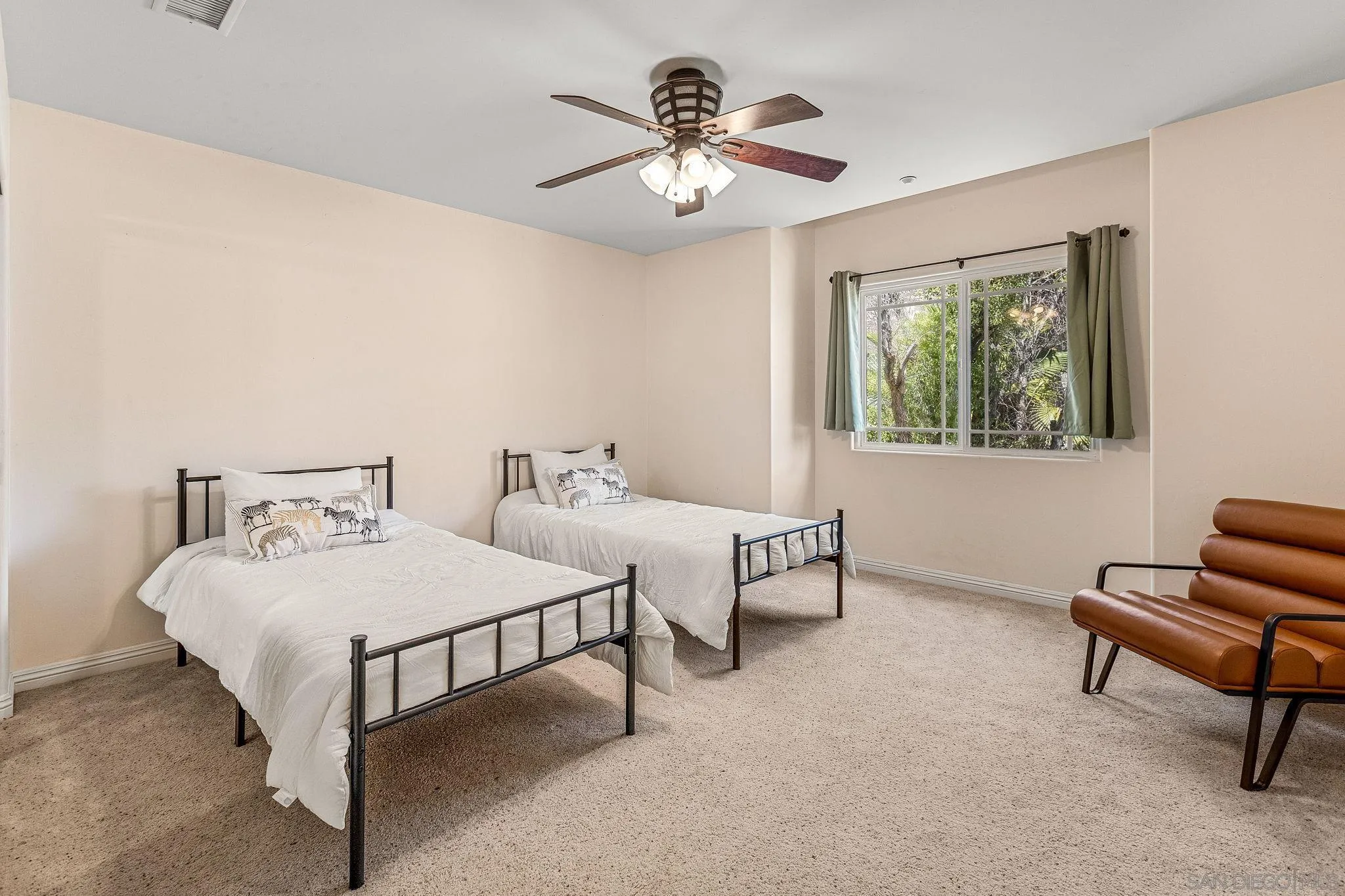 25919 Matlin Road Ramona, CA 92065 - Photo 21 of 42 a bedroom with a bed and a chandelier