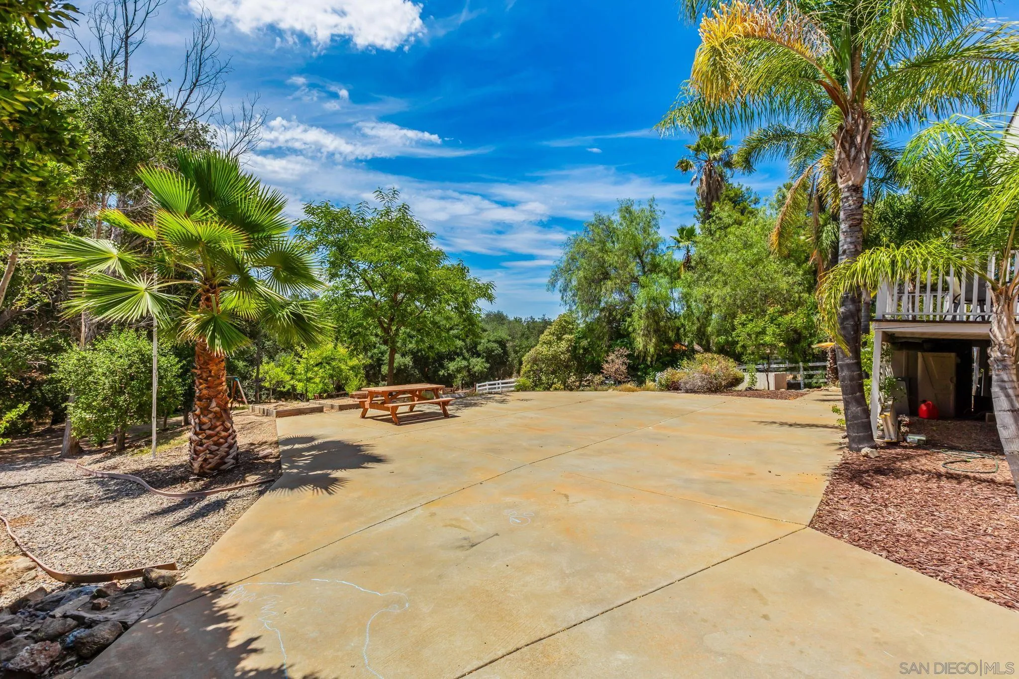 25919 Matlin Road Ramona, CA 92065 - Photo 26 of 42 a view of a patio with a table and chairs under an umbrella