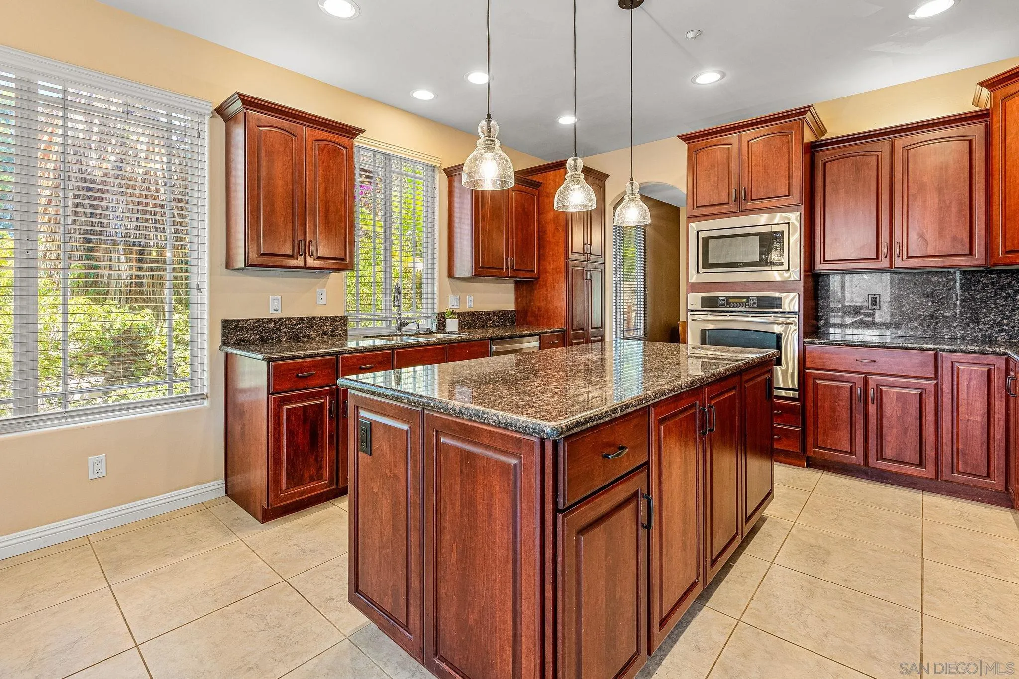 25919 Matlin Road Ramona, CA 92065 - Photo 4 of 42 a kitchen with stainless steel appliances granite countertop a stove a sink and a refrigerator