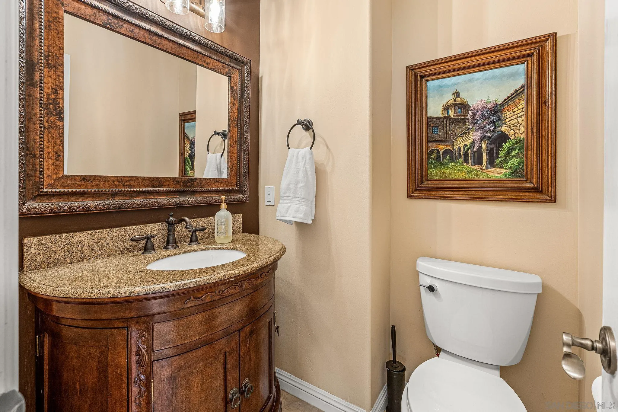 25919 Matlin Road Ramona, CA 92065 - Photo 10 of 42 a bathroom with a toilet a sink and mirror