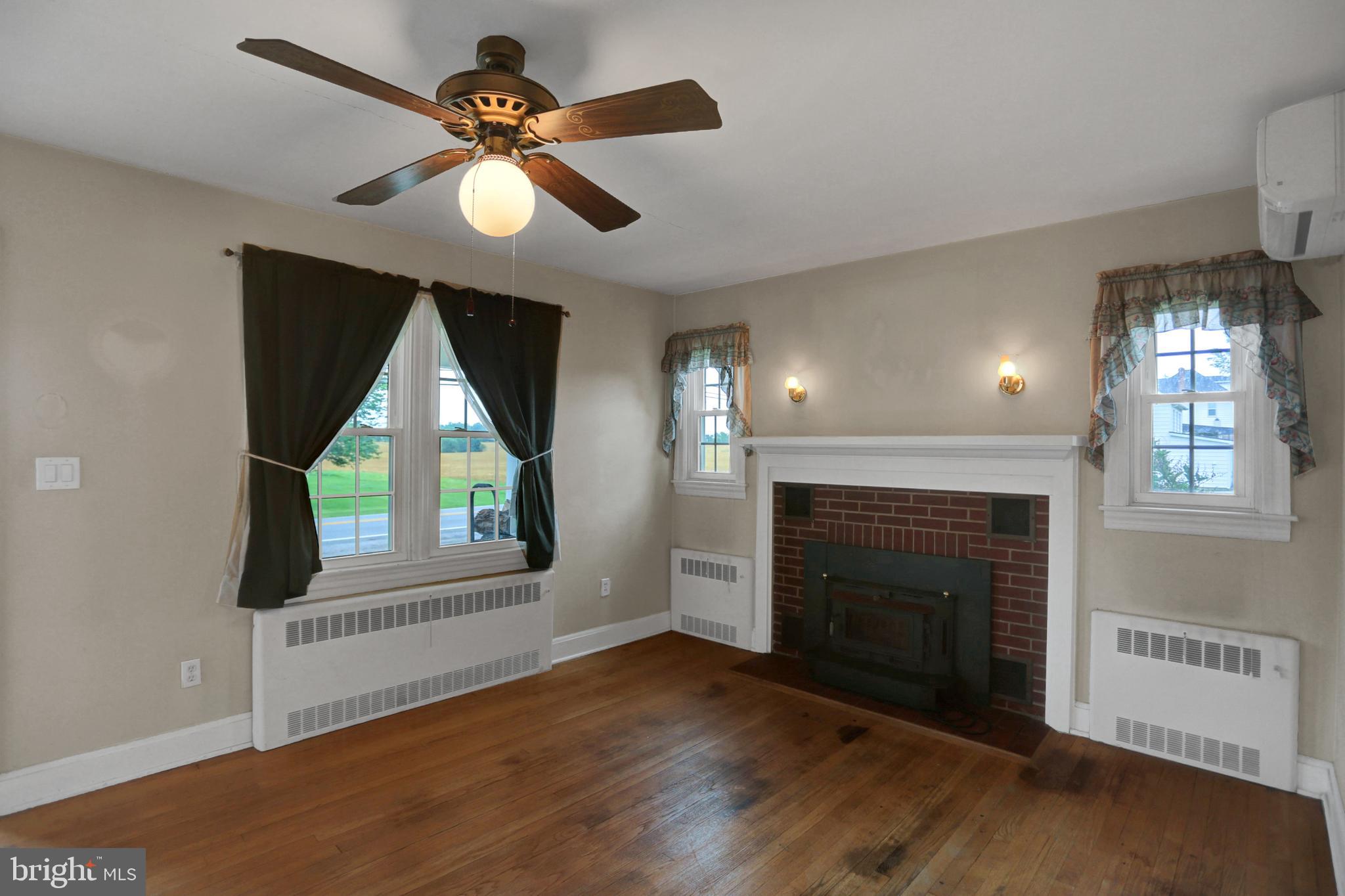 6119 Middleburg Road Keymar, MD 21757 - Photo 10 of 50 a view of an empty room with wooden floor fireplace and a window