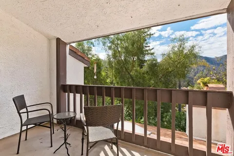 a view of a chair and table in the balcony