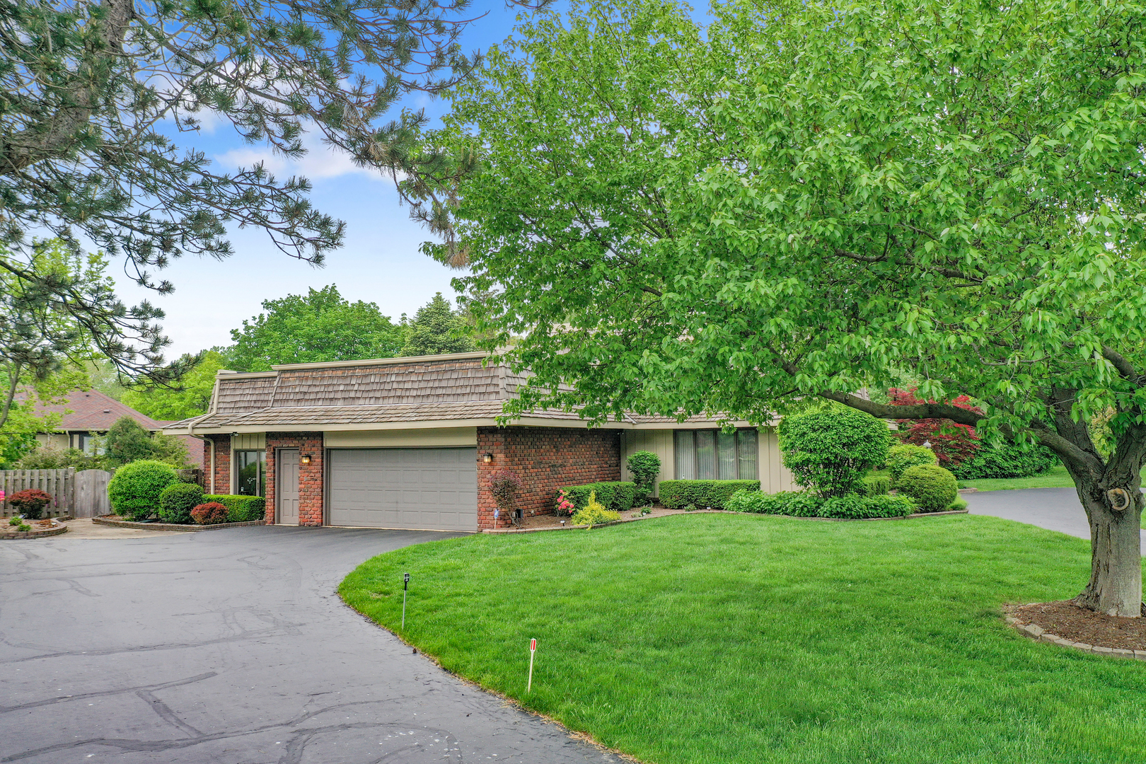 9 Hampton Drive Oak Brook, IL 60523 - Photo 22 of 27 a front view of a house with a yard and trees