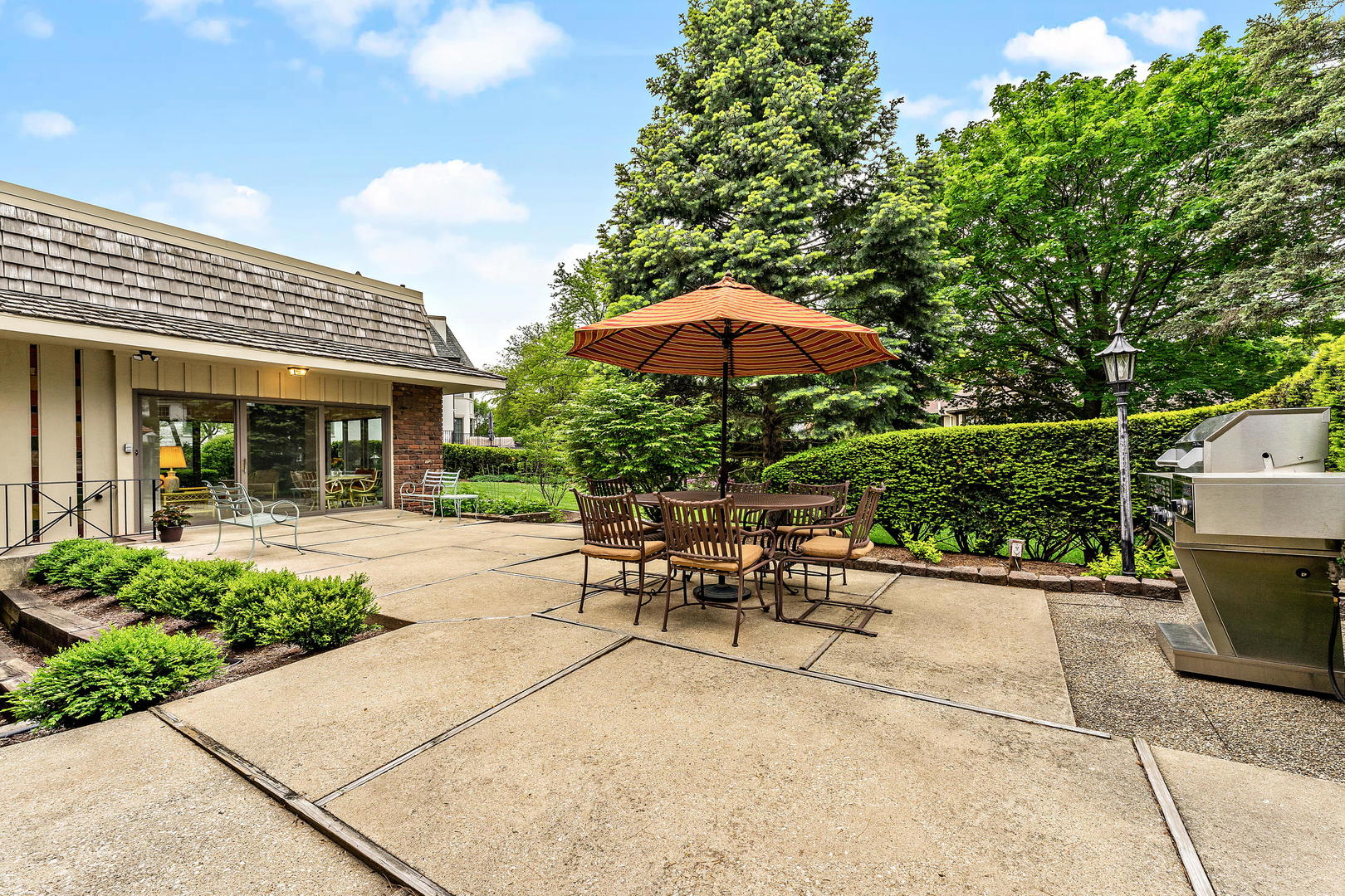 9 Hampton Drive Oak Brook, IL 60523 - Photo 8 of 27 a view of a patio with table and chairs under an umbrella
