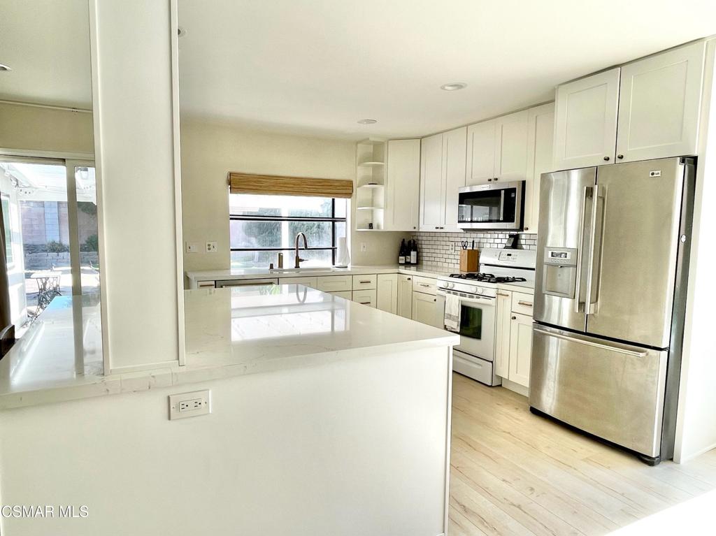 1594 Willowbrook Lane Simi Valley, CA 93065 - Photo 4 of 20 a kitchen with stainless steel appliances granite countertop a refrigerator a stove a sink and a view of living room
