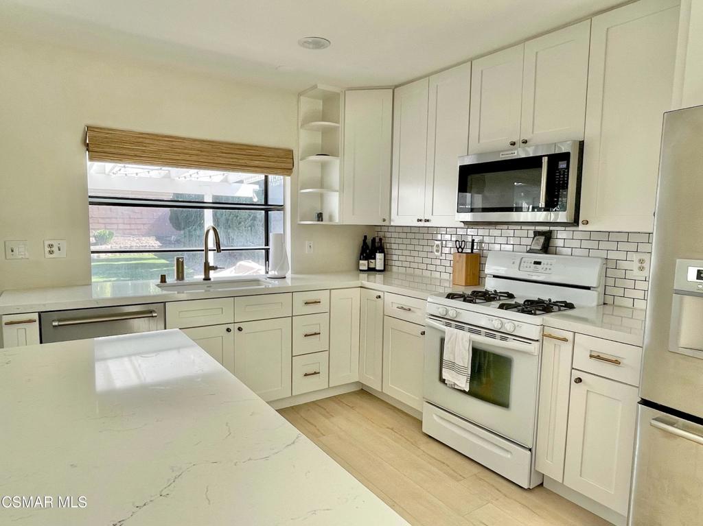 1594 Willowbrook Lane Simi Valley, CA 93065 - Photo 7 of 20 a kitchen with cabinets stainless steel appliances and a window